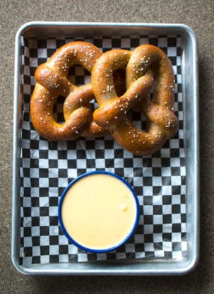A pretzel and dipping sauce 