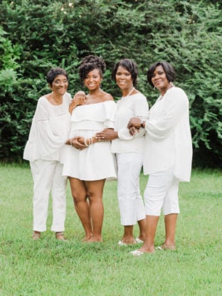 Jocelyn Delk Adams with her grandmother, mother and aunt all dressed in white 