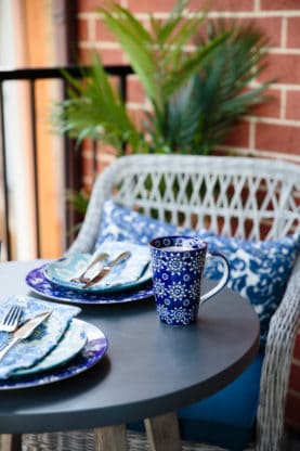 Home Goods plates, silverware, coffee mug and outdoor furniture