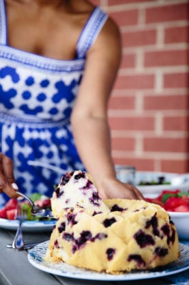 Jocelyn cutting a slice of blueberry orange cake 