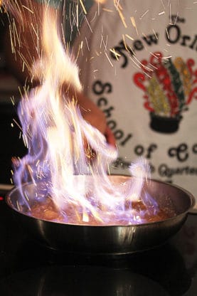 A flambé dish being cooked at the New Orleans School of Cooking