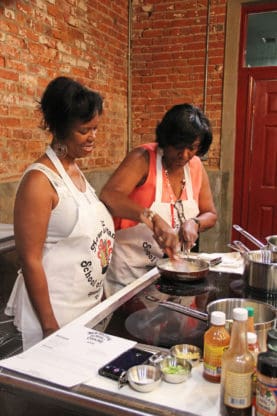 Jocelyn's mom, left, and aunt taking a cooking class at the New Orleans School of Cooking