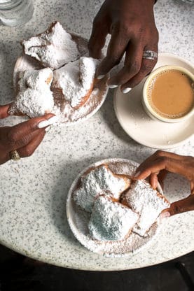 Overhead shot of coffee and beignets at Cafe Du Monde in NOLA