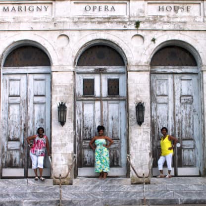 Jocelyn posing for a photo on the steps of the Marigny Opera House in New Orleans with her mom and aunt
