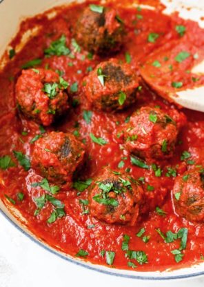 Vegetarian lentil meatballs simmering in a rich tomato sauce
