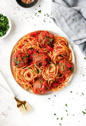 A white plate filled with vegetarian spaghetti and meatballs ready to serve