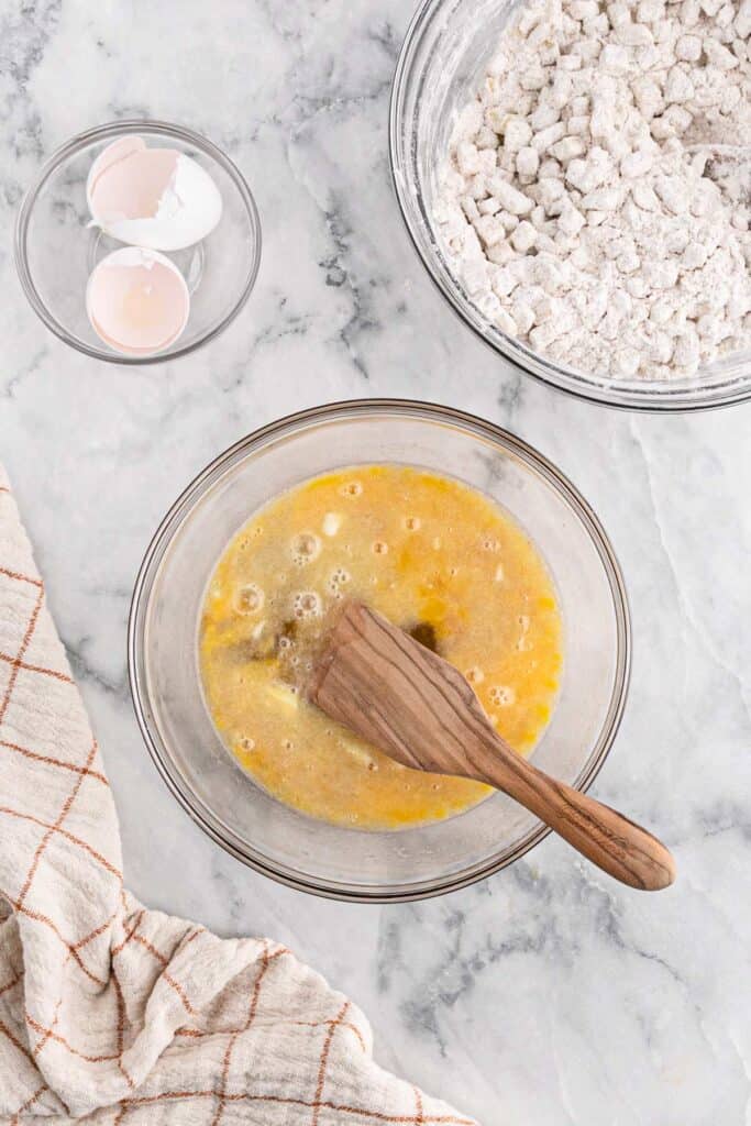 Mixing the egg and other wet ingredients together to make a batter