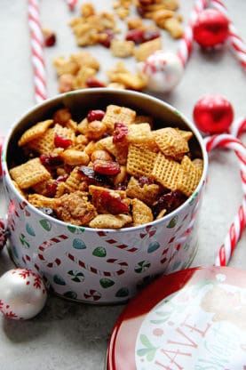 A container of Cranberry Orange Chex Mix Christmas Recipe ready to give away for the holidays