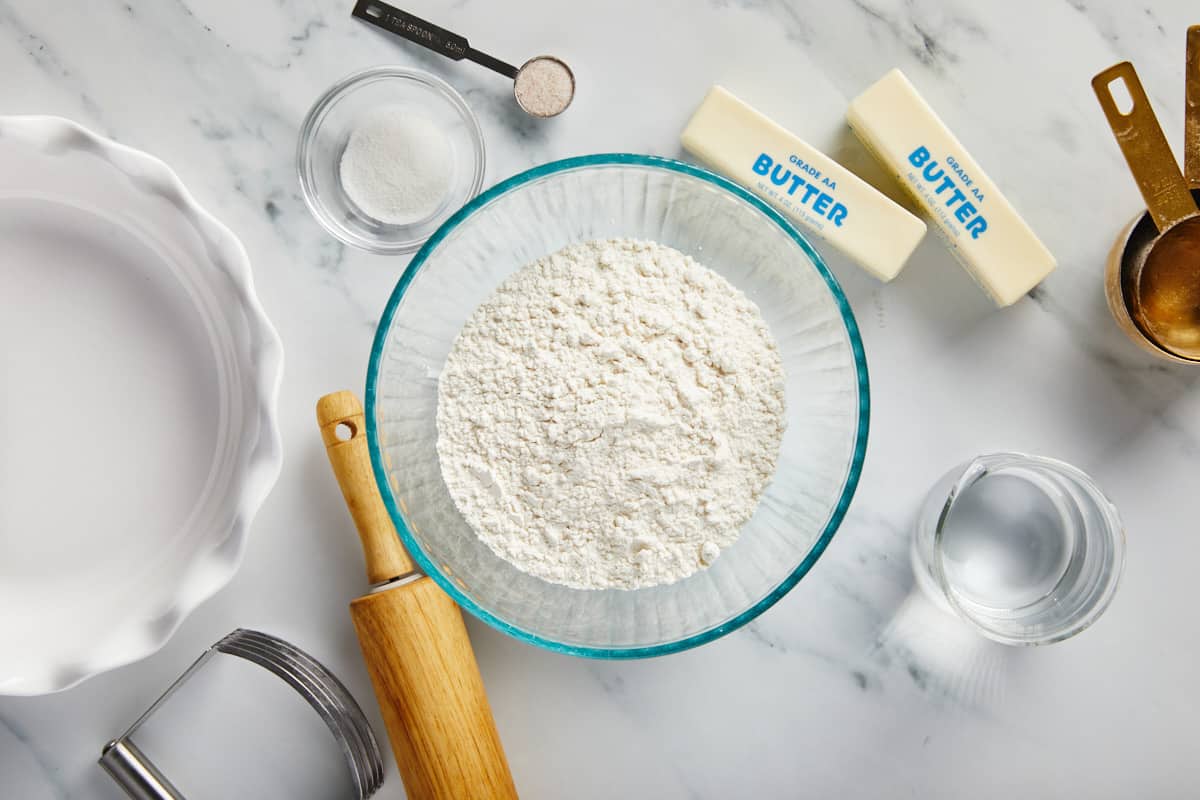 Ingredients to make a flaky  pie crust on the table before mixing.