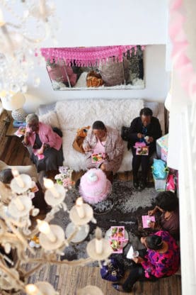 Overhead shot of baby shower attendees sitting and eating