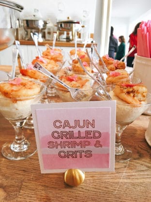 Several bowls of cajun grilled shrimp and grits with forks in them