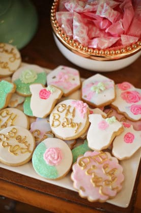 A set of baby shower cookies and candies from the dessert table