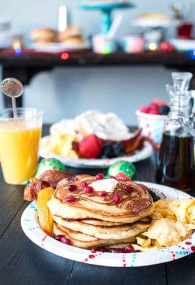 Ginger Orange Pancakes recipe on plate with eggs and bacon with juice in background ready to serve