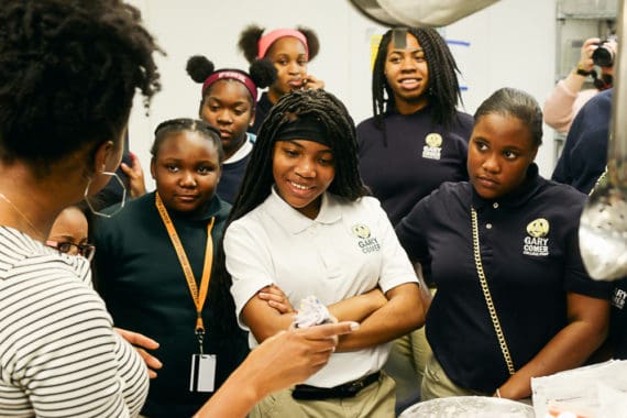 Attentive students listen and watch Jocelyn's baking instruction