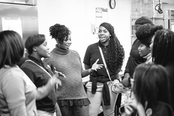 Black and white photo of Jocelyn speaking with her baking students