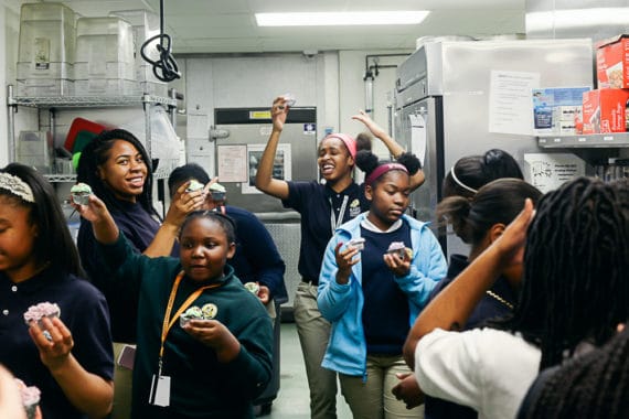 Female students enjoying cupcakes they baked