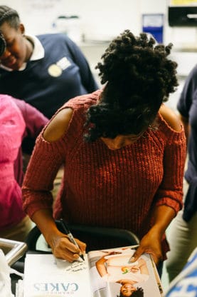 Jocelyn signing copies of her cookbook for the students