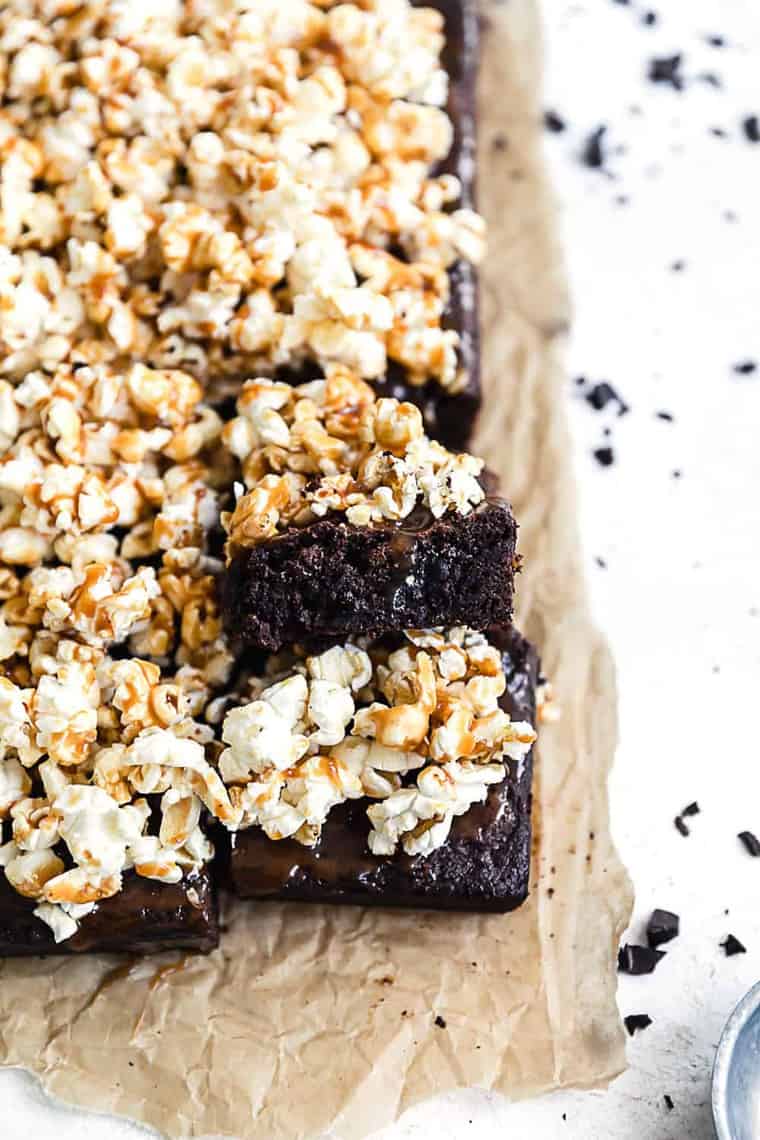 Several Salted Caramel Popcorn Brownies on top of parchment paper