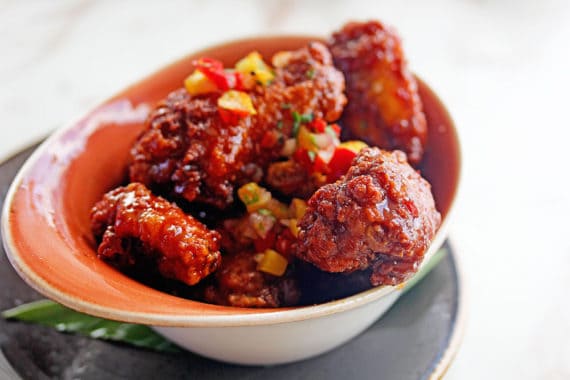 Mango Sweet Chili Wings served in a colorful bowl at Kapa Bar and Grill in Maui, Hawaii