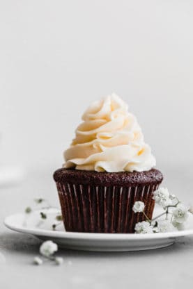 Close up of one single Easy chocolate cupcake with buttercream frosting on top.