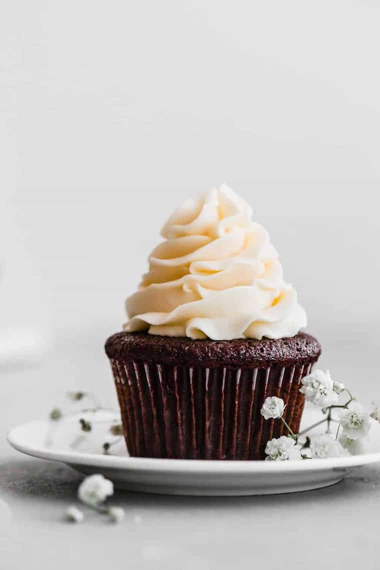 Close up of one single best chocolate cupcake with buttercream frosting on top.