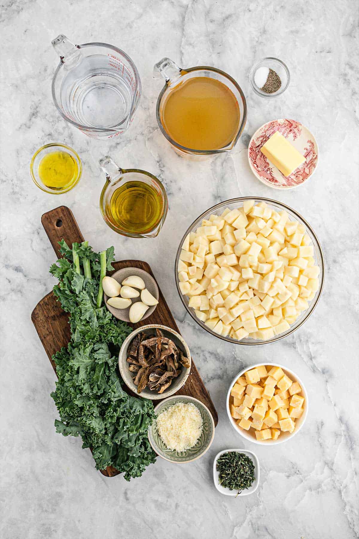 Ingredients to make kale potato soup on the table.