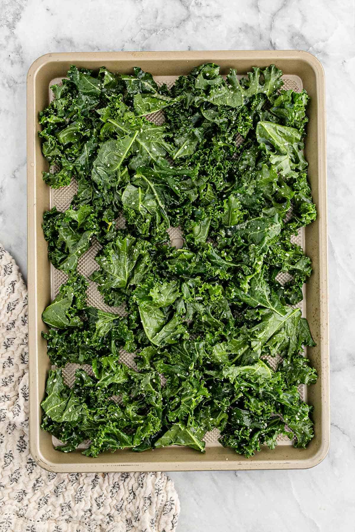 The kale spread out onto a baking tray.