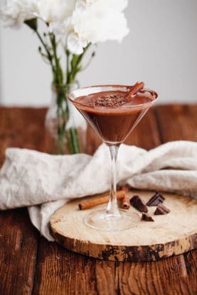 A decadent and rich Chocolate martini recipe with cinnamon sticks and chocolate ready to serve