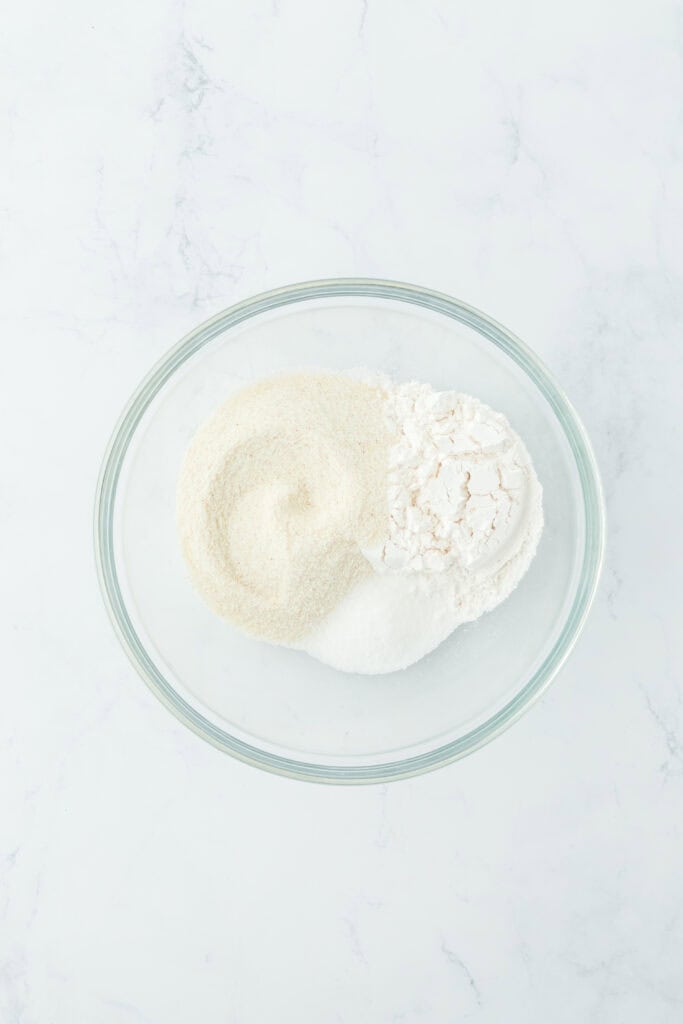 Dry ingredients in a glass bowl on a white countertop