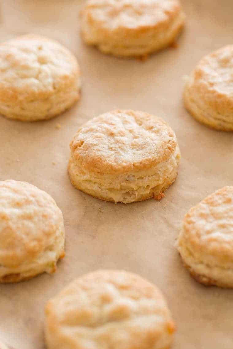 Bacon Cheddar Biscuits on parchment paper baked coming out of the oven