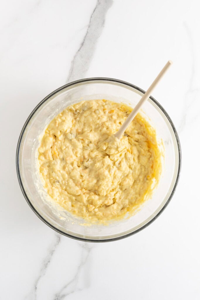 Well mixed Mexican cornbread batter in a glass bowl