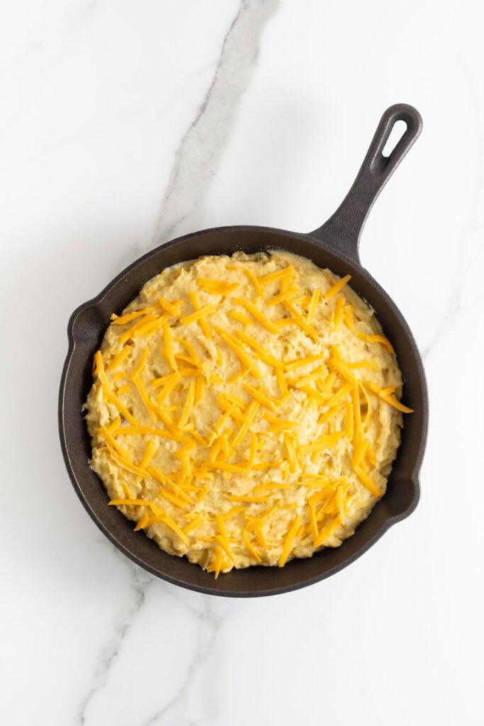Mexican cornbread batter in a cast iron skillet before baking