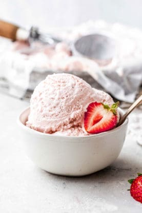 Photo of two scoops of Homemade Strawberry Ice Cream recipe in white bowl with spoon
