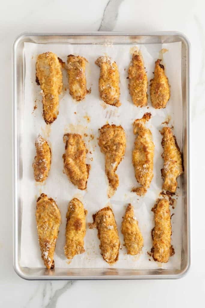 Finished oven fried chicken on a baking sheet