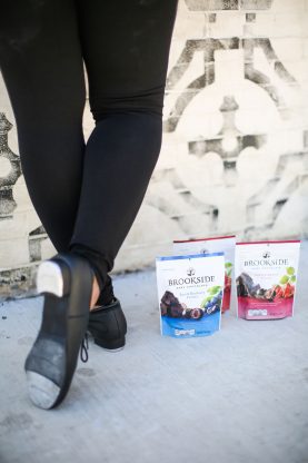 Jocelyn's tap shoes next to three packs of Brookside chocolate packages