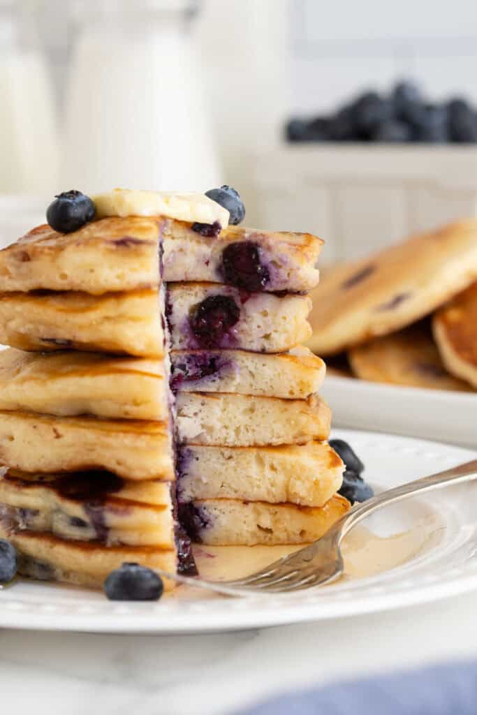 Blueberry pancake recipe  stack cut into on a large white plate