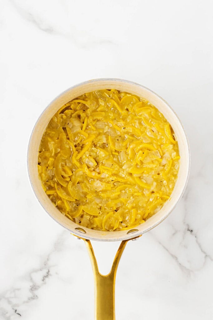 Cooked down sauteed yellow squash in a pot