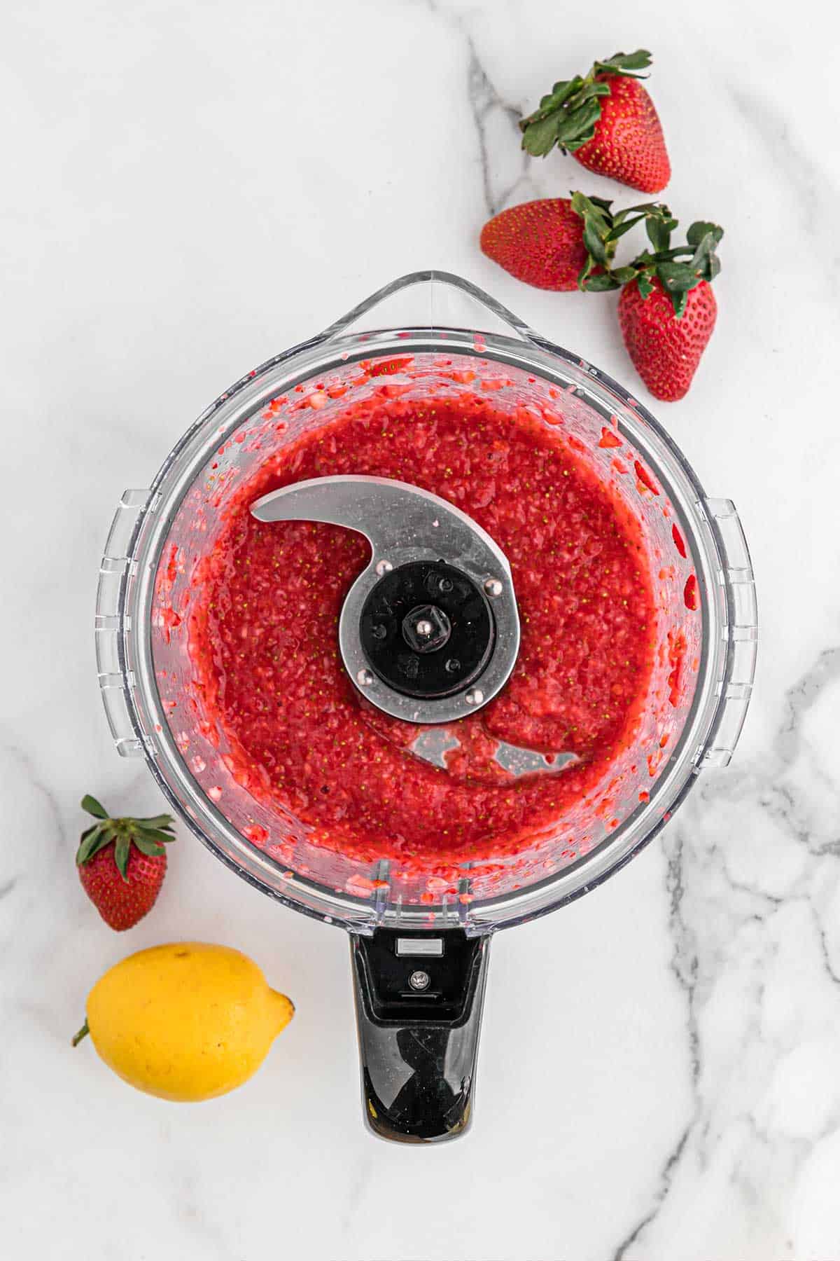 Strawberries pureed in a food processor.