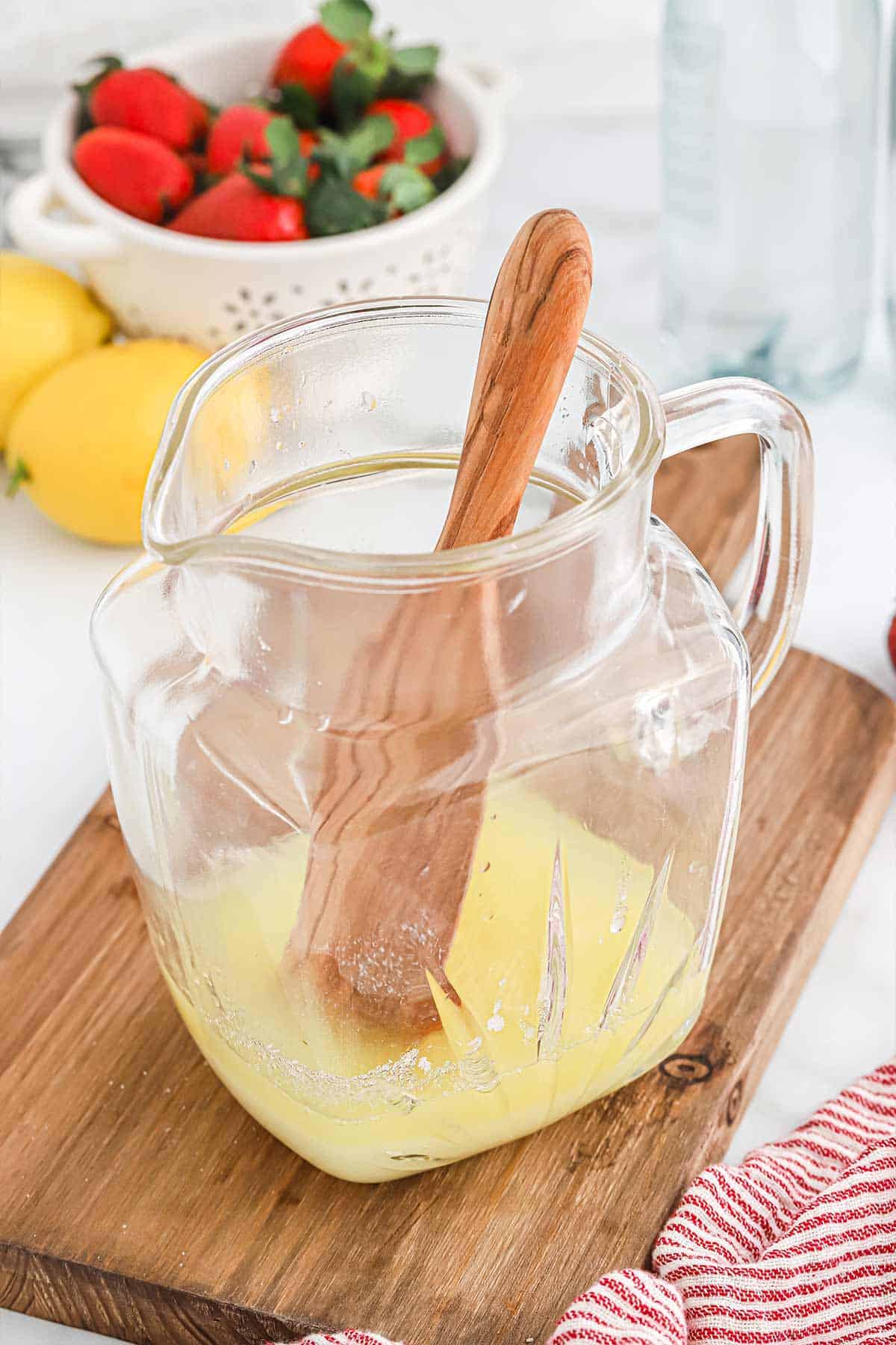 Lemon juice in a pitcher to make homemade lemonade.