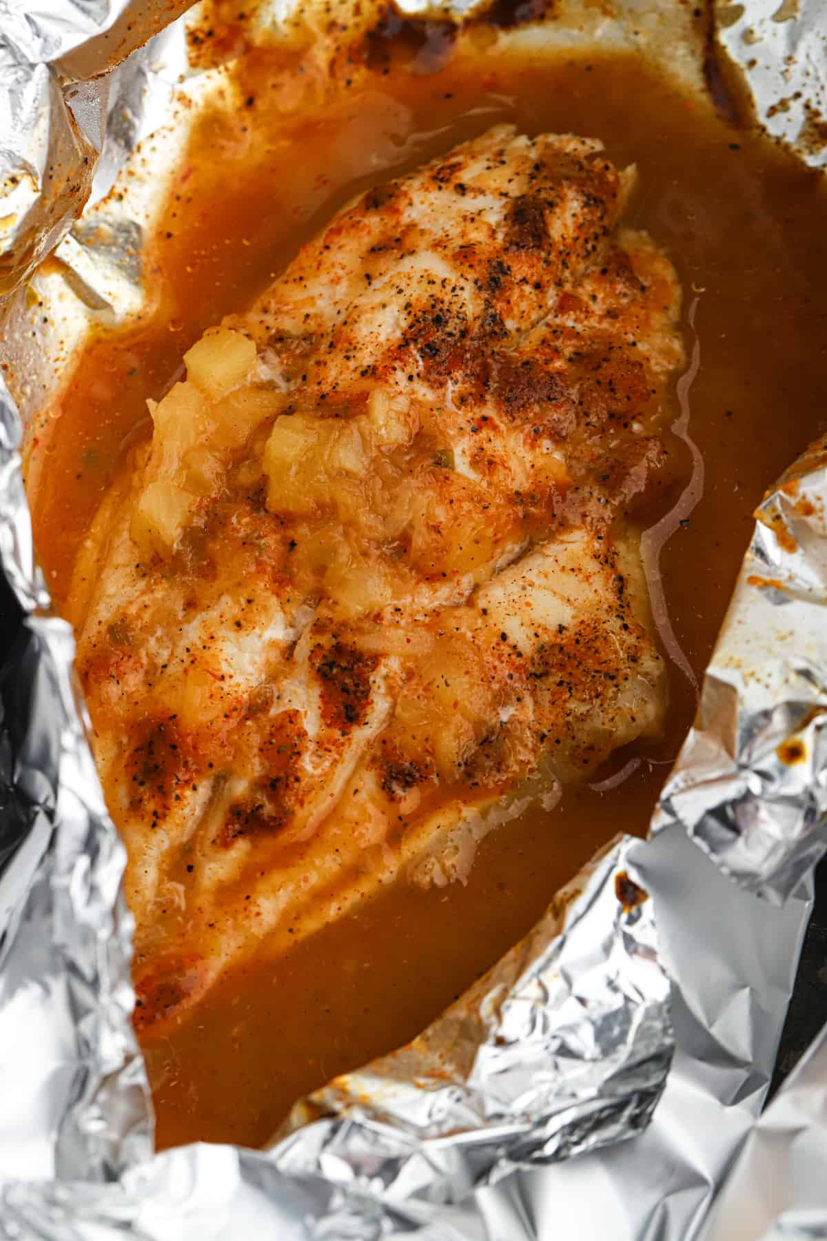 Grilled catfish with a pineapple honey bourbon marinade cooked in foil.