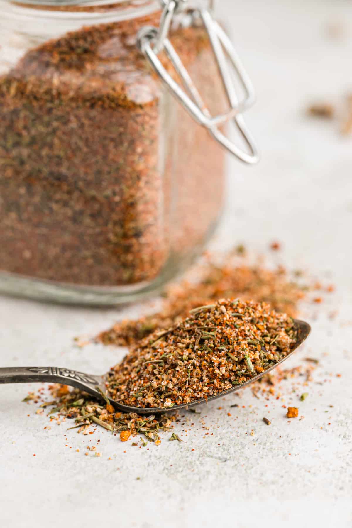 cajun seasoning on a spoon outside of a jar