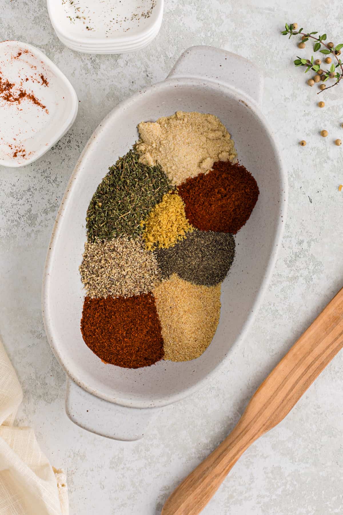 Various spices separated in a large white vessel