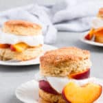 Peach Shortcake Recipe- Buttery flaky shortcake biscuits get topped with brown sugar soaked ripe peaches and fluffy whipped cream for the ultimate summer delight. #peach #peaches #shortcake #biscuits