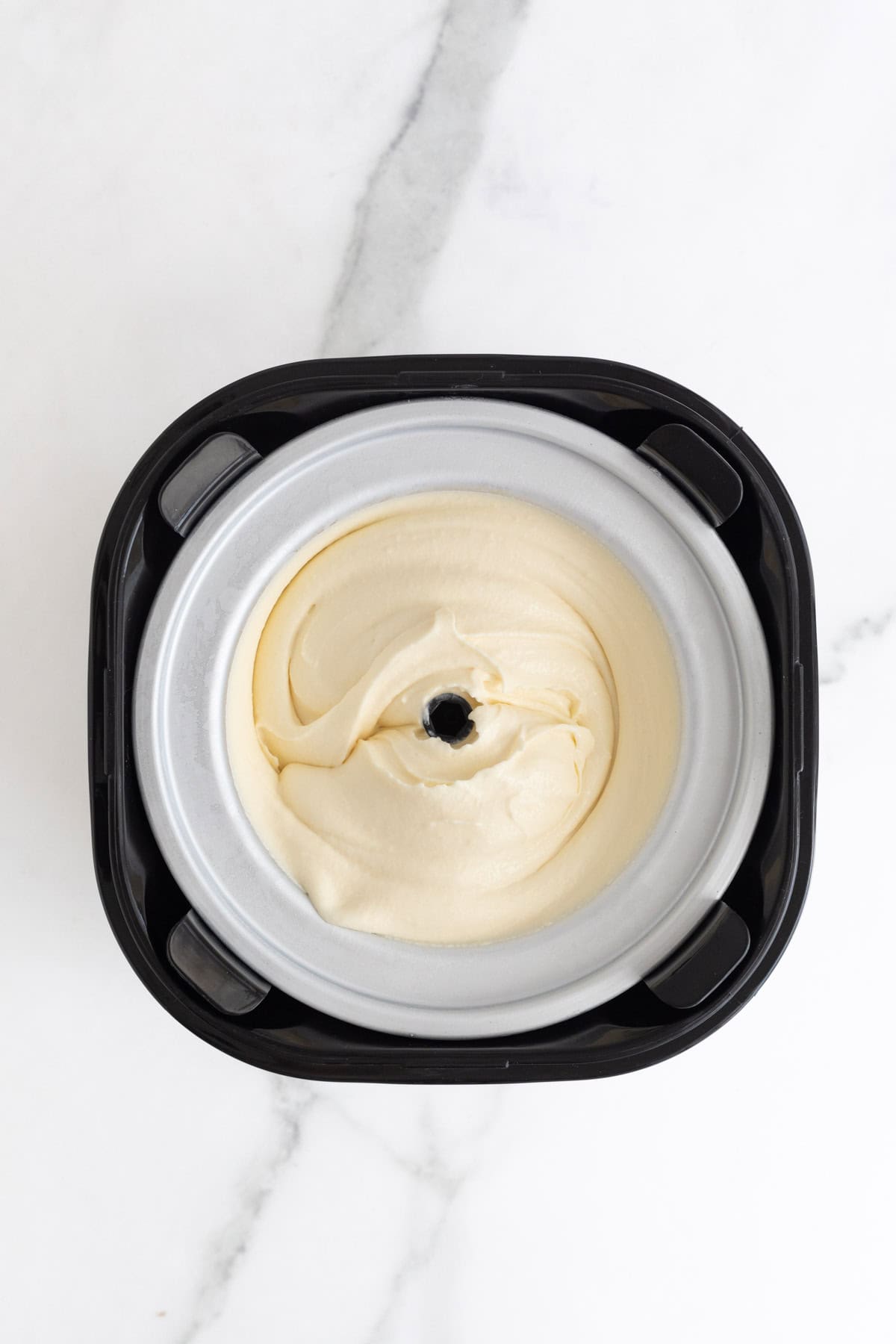 Custard beginning to churn inside the ice cream maker