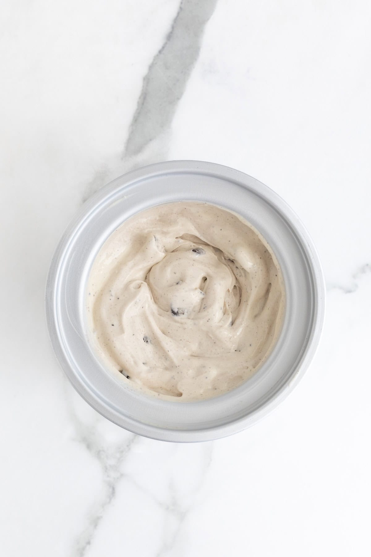 Cookies and cream ice cream fully churned, with a creamy texture and cookie flecks throughout