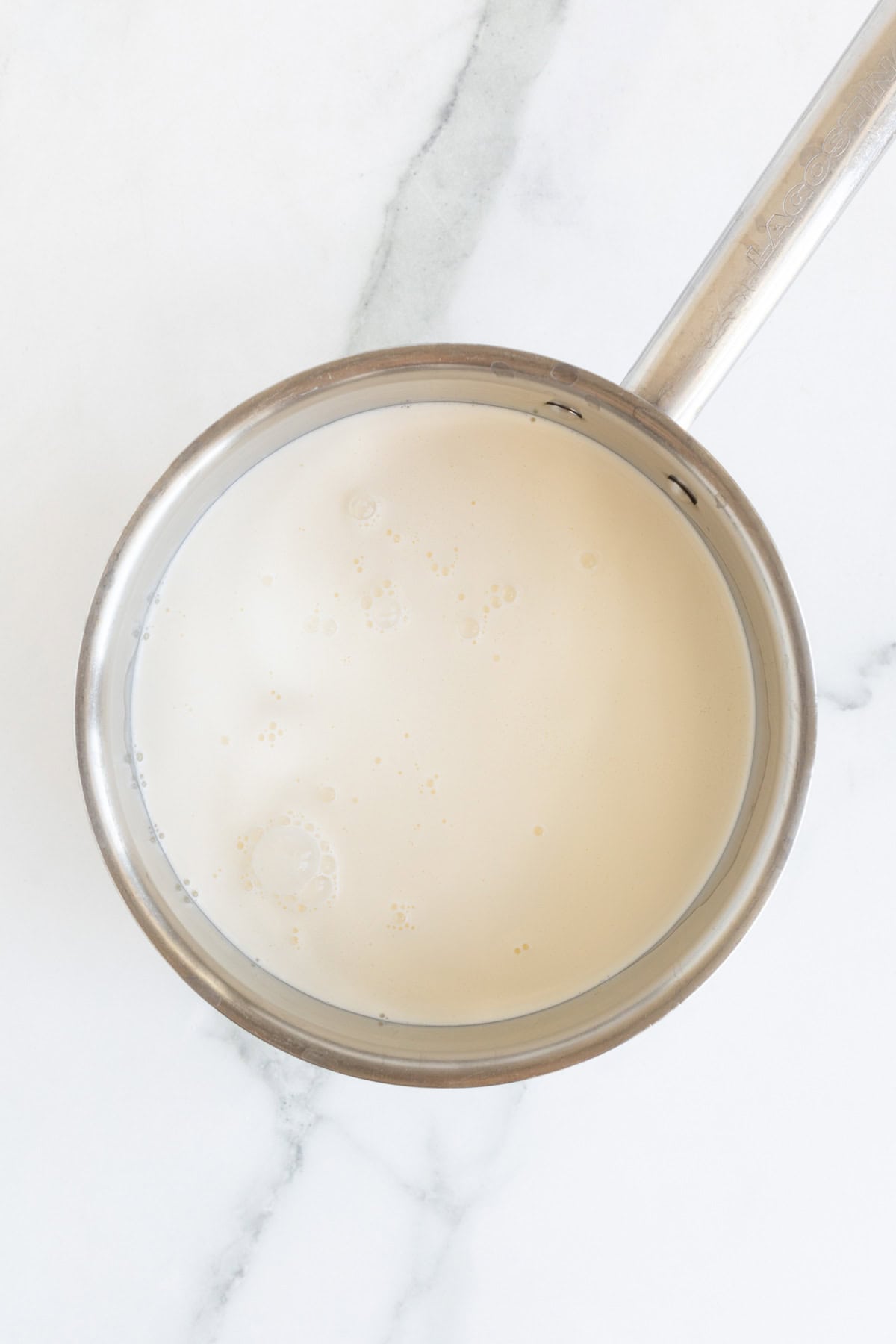 Warm cream mixture in a saucepan, ready to be tempered into the eggs