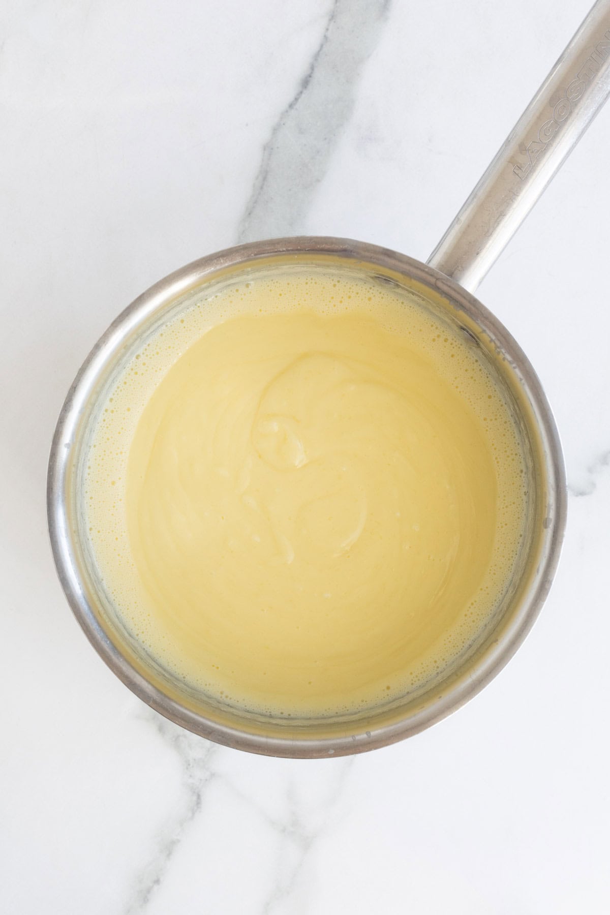 Cooked custard in a saucepan, smooth and thickened