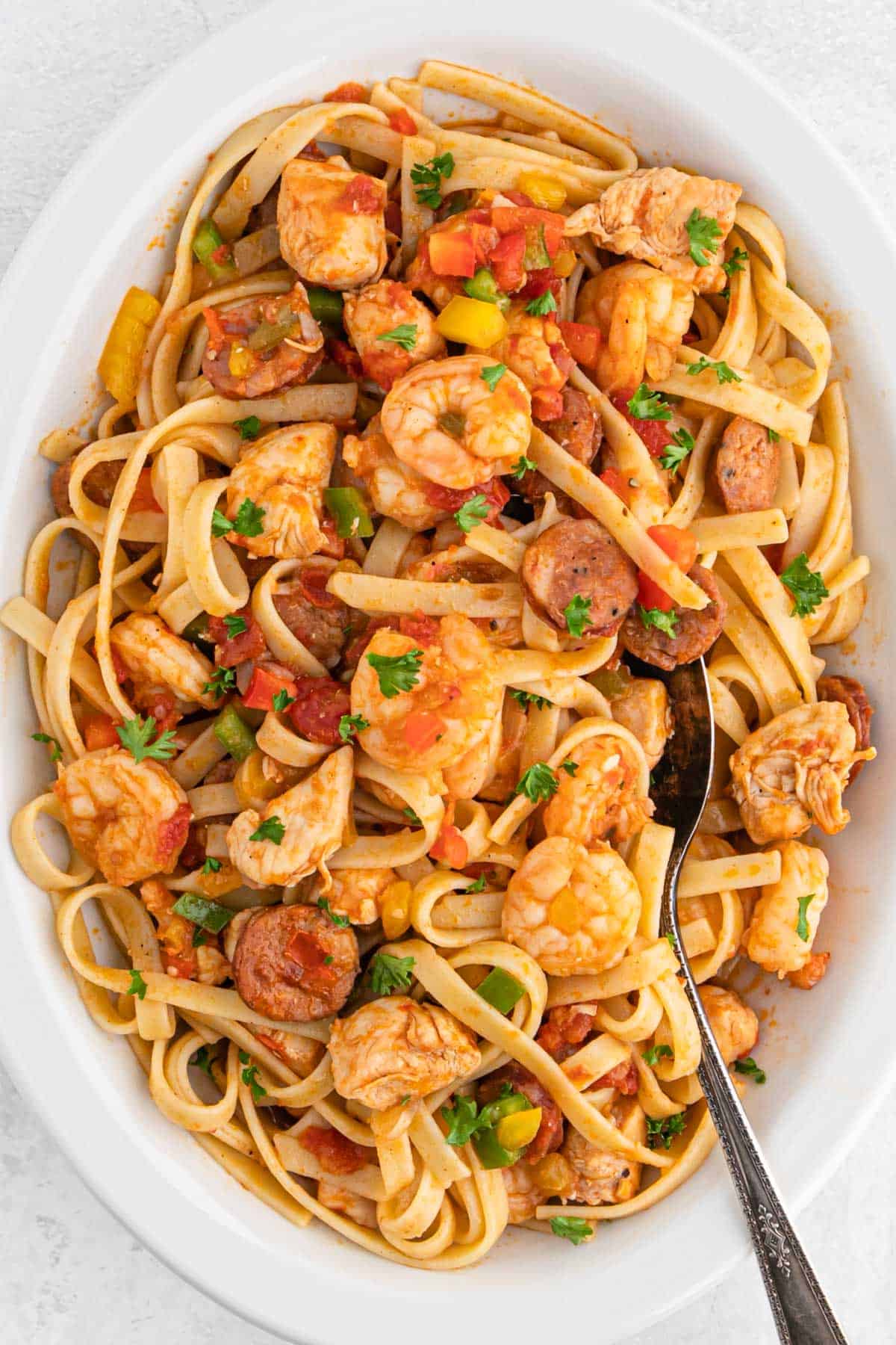 A large white platter of cajun jambalaya pasta