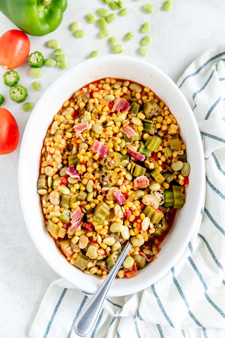 An overhead image of a large bowl of Succotash against a white background