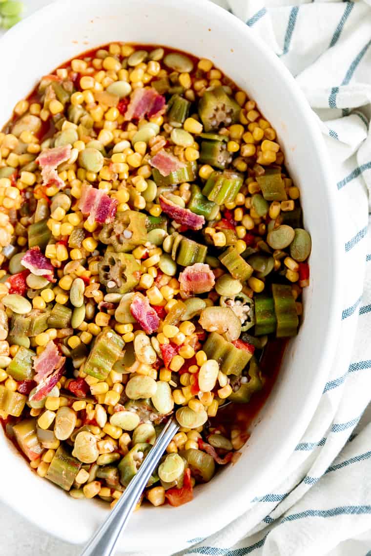 A close up photo of Corn Succotash recipe against white background and striped towel